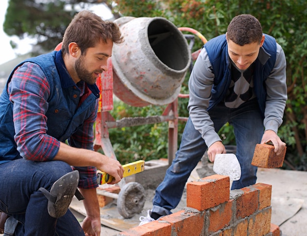men tools bricks outdoor with cement construction building masonry job skill young people bricklayer artisan talking with equipment builder worker wall 590464 327756